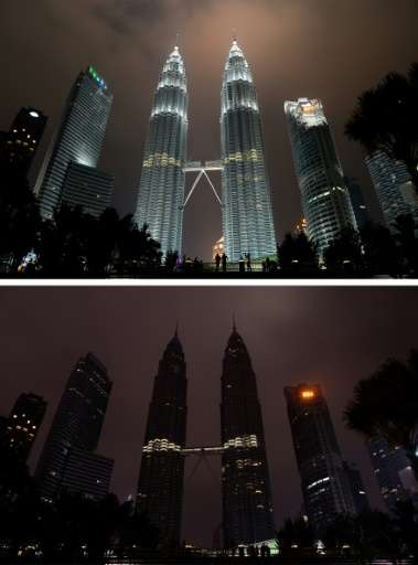 This combination of pictures created on March 19, 2016 shows the Petronas towers before (top) and after the lights were switched