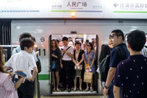This picture taken on July 19 shows commuters in the morning rush hour on line 2 of the Shanghai Metro in Shanghai