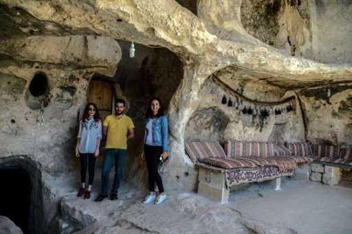 Tourists in the caves at  Hasankeyf. Turkish authorities have said they will rehouse residents displaced by the dam project