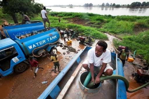 Truck drivers collect water directly from the Nile river to distribute to residents in Juba, South Sudan