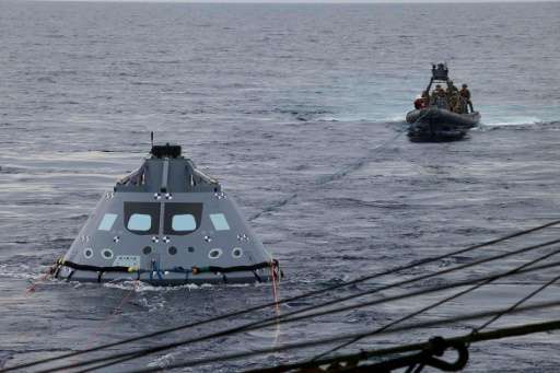 US Navy divers and other personnel practicing for recovery of Orion on its return from deep space missions, using a test version