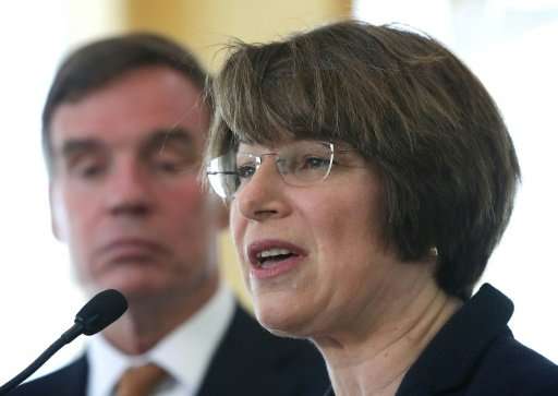 US Senators Amy Klobuchar and Mark Warner, seen in a 2016 file picture, endorse a bill to require internet firms to disclose the