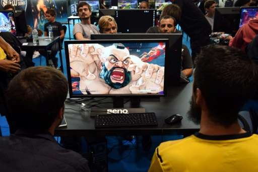 Video game players compete against each other, at the Palais des Congres in Bordeaux, France, during the eSports World Conventio