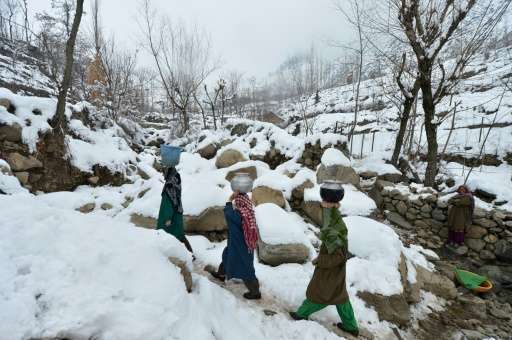 Villagers carry drinking water on the outskirts of Srinagar