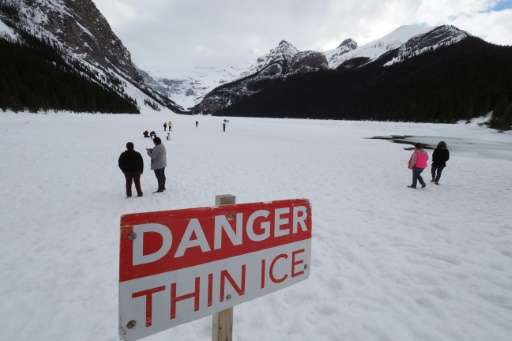 Visitors walk on frozen Lake Louise at Banff National Park in Alberta. The government has increased funding for Parks Canada but