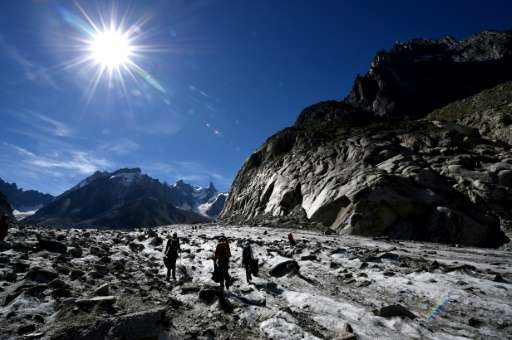 Volunteers collect wastes on the Mer de Glace glacier in Chamonix-Mont Blanc, French Alps, on September 2, 2016 during the annua