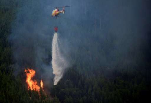 Water-bombing planes and helicopters continued their runs over the blaze, which has been burning since Saturday