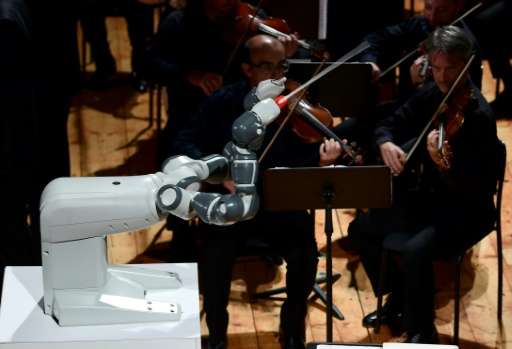 YuMi, designed by Switzerland's ABB, conducts the Lucca Philharmonic Orchestra on Tuesday at the Teatro Verdi in Pisa, Italy