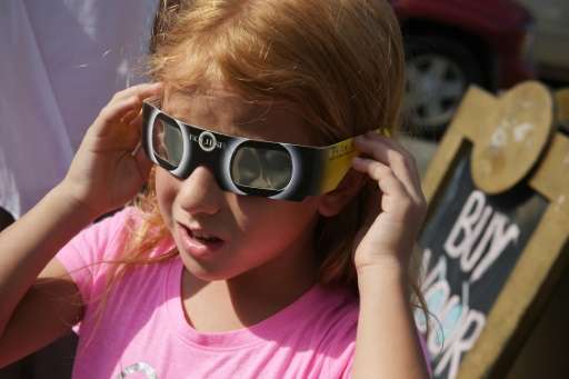 Zoe Spyridonos tries out eclipse glasses in Charleston, South Carolina ahead of the total solar eclipse on August 21, 2017