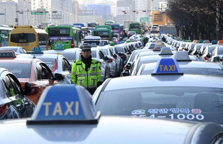 An estimated 50,000 taxi drivers protested in Seoul to call for a car-pooling app to be banned