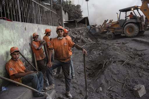 At Guatemala volcano, weather and danger halt search