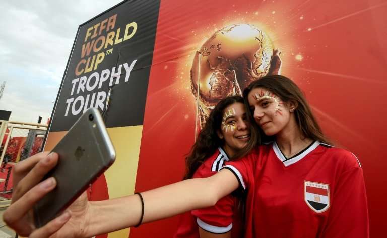 Football fans pose for a &quot;selfie&quot; photograph taken with an iPhone in this file picture taken in Cairo on March 15, 201