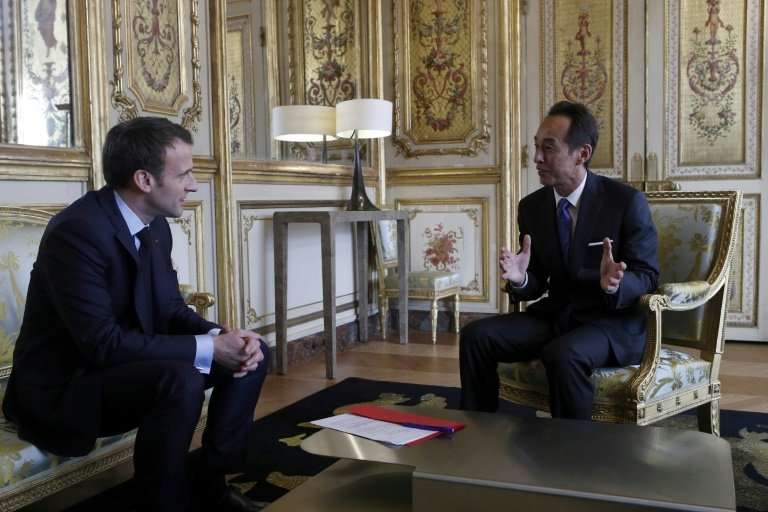 French President Emmanuel Macron meets with Samsung Electronics president and chief strategy officer,  Young Sohn, at the Elysee