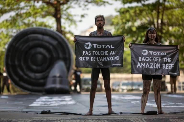 Greenpeace activists stage a protest in Rio de Janeiro against Total's planned oil exploration near a huge coral reef off the co