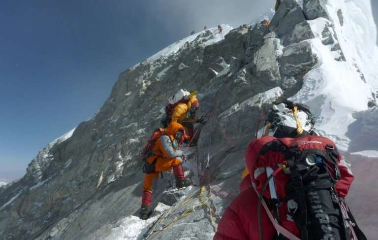 Mountaineers walk past the Hillary Step while pushing for the summit of Mount Everest on the south face from Nepal, in a file ph