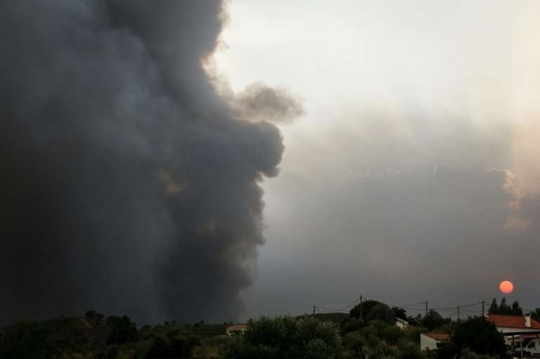 Smoke rises from a wildfire close to Monchique in the Algarve, southern Portugal, where more than a 1,000 firefighters are battl