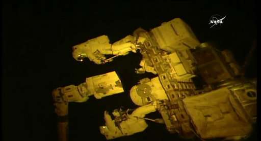 Spacewalking astronauts give new hand to robot arm