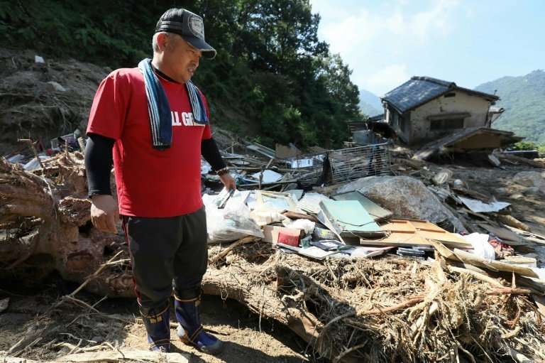 Tens of thousands of rescue workers are still digging through the debris for bodies after Japan's worst weather-related disaster
