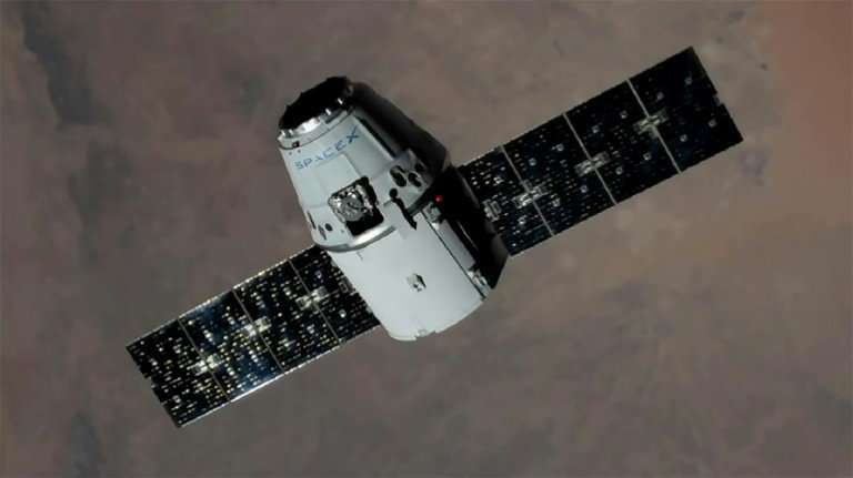 This NASA handout image shows an unmanned SpaceX Dragon cargo craft approaching the International Space Station in August 2017