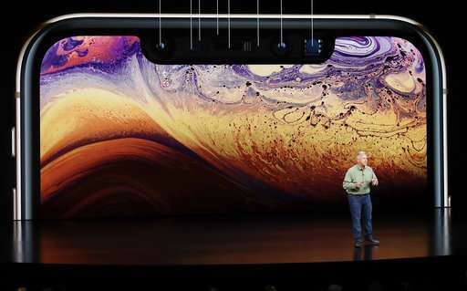 The Latest: Apple ups ante on larger iPhone screens