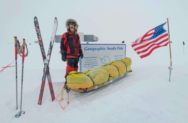 American adventurer Colin O'Brady poses for a photo at the Geographic South Pole sign in Antarctica