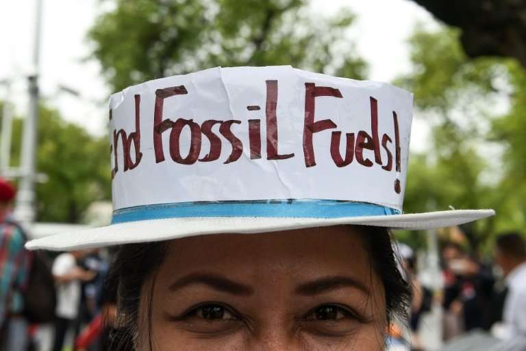 An environmental activist takes part in a demonstration in front of the United Nations building in Bangkok on September 8, 2018