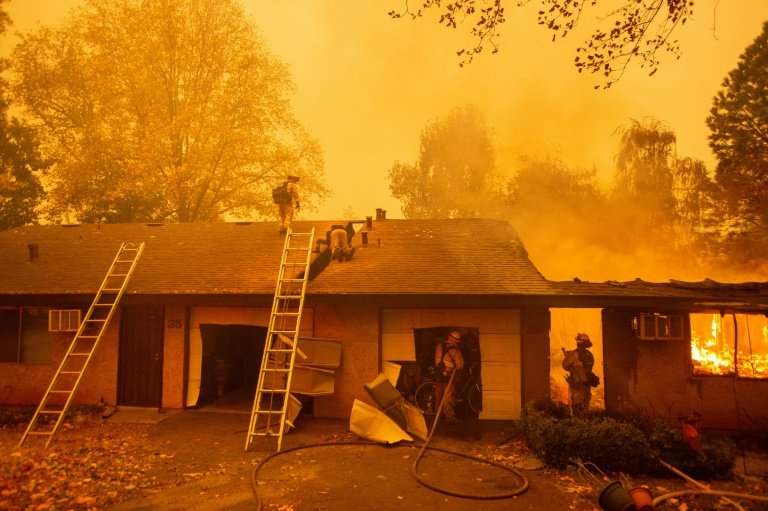Firefighters battle flames at the Shadowbrook apartment complex in Paradise, north of Sacramento, California—the town has been r