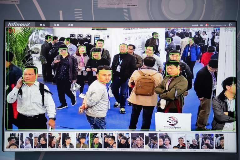 Facial-recognition screens analysing candid shots of conference attendees were scattered around the exhibition hall
