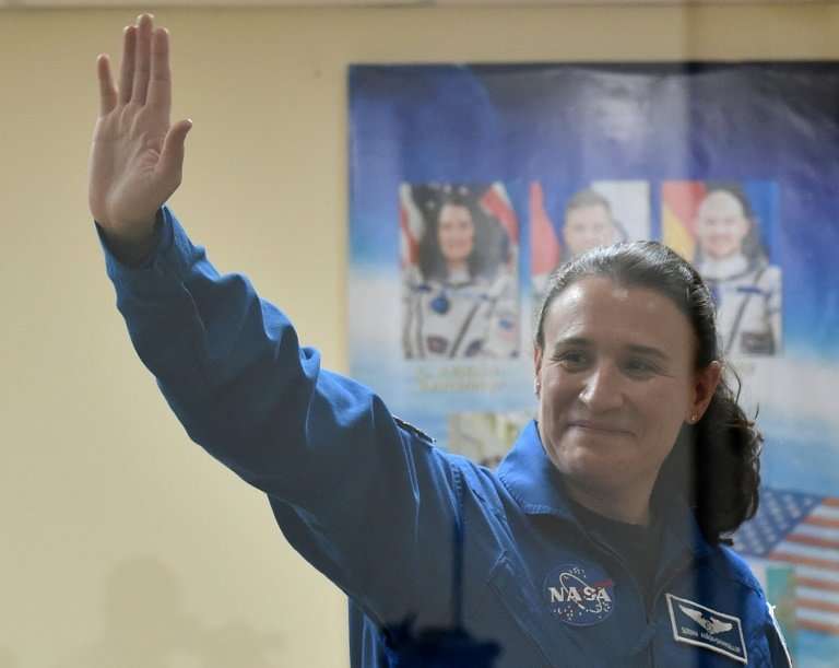 NASA astronaut Serena Aunon-Chancellor waves during a press conference at the Russian-leased Baikonur cosmodrome in Kazakhstan b