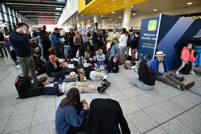 Passengers wait at the North Terminal at London Gatwick Airport,as police frantically searched for the operators of the drones t
