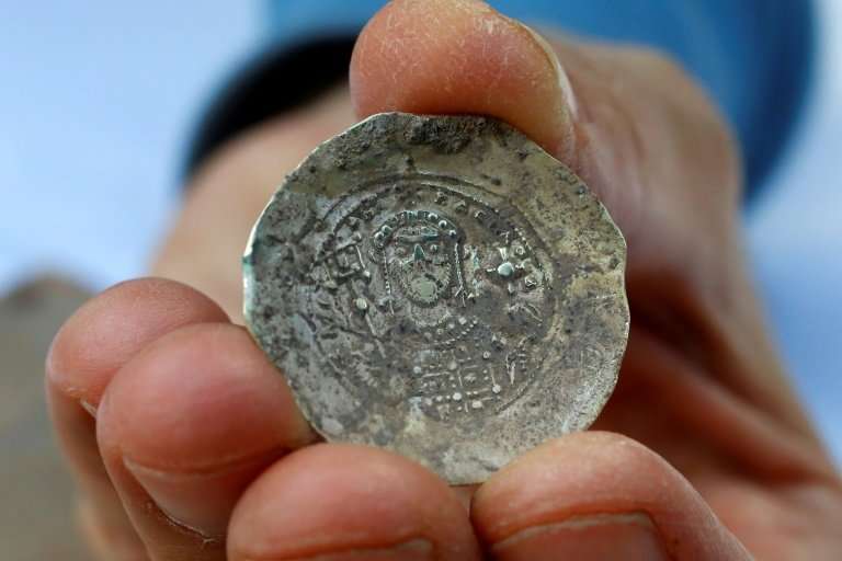 A picture taken on December 3, 2018, shows an ancient gold coin uncovered at an excavation site in the Israeli Mediterranean tow