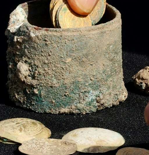 A picture taken on December 3, 2018, shows ancient gold coins and an earring uncovered at an excavation site in the Israeli Medi