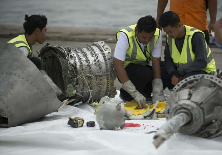 Investigators examine engine parts from the ill-fated Lion Air flight JT 610, after they were recovered from the bottom of the J
