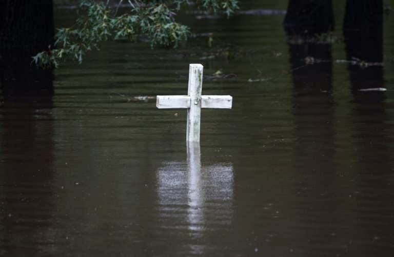 A cross is seen in flood water at a cemetery in Grifton, North Carolina