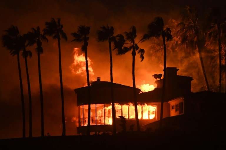 A house burns in the Hollywood resort town of Malibu—about 88,000 homes have been evacuated in Los Angeles and Ventura counties