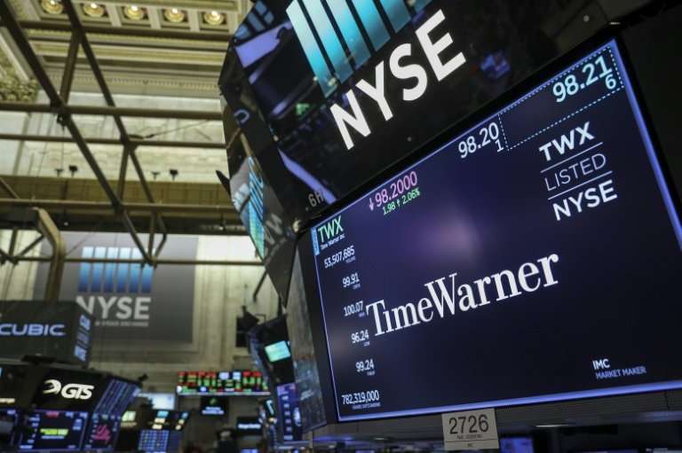 A logo and trading information for Time Warner is seen on a monitor on the floor of the New York Stock Exchange (NYSE), on June 