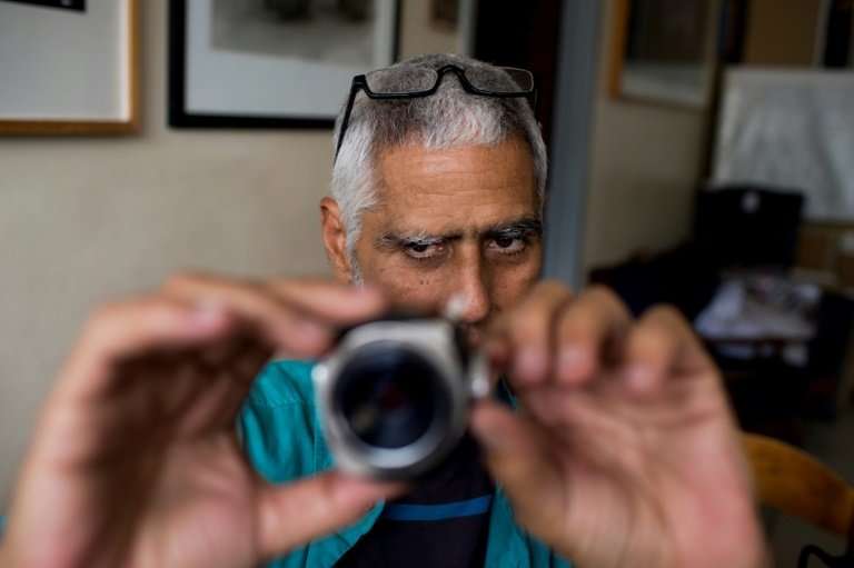Although working with equipment and techniques that have virtually disappeared, he carries on as if digital photography does not