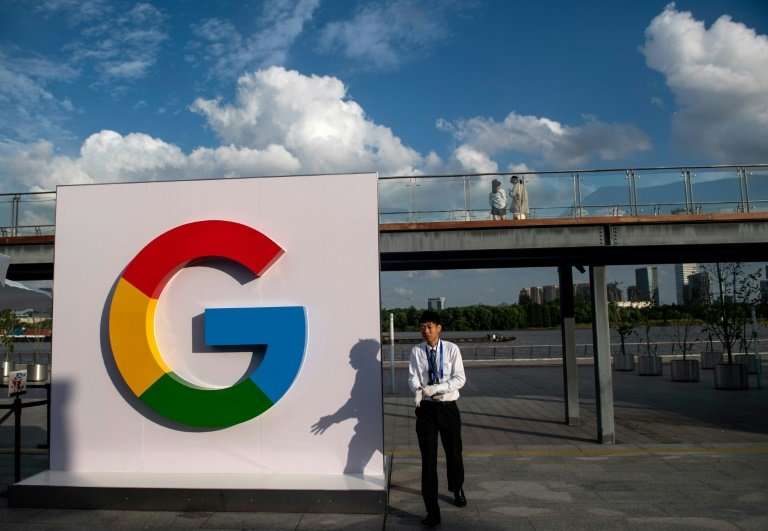 A man passes a Google sign in Shanghai on  September 26, 2018. Google announced that it will test a video game streaming platfor