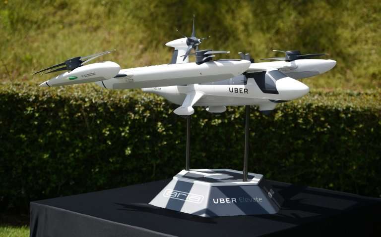 A model of Uber's electric vertical take-off  and  landing vehicle concept (eVTOL) flying taxi is displayed at the second annual