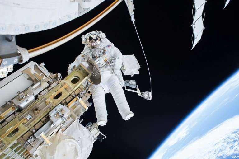 An astronaut goes on a spacewalk outside the International Space Station, where he may soon be joined by tourists