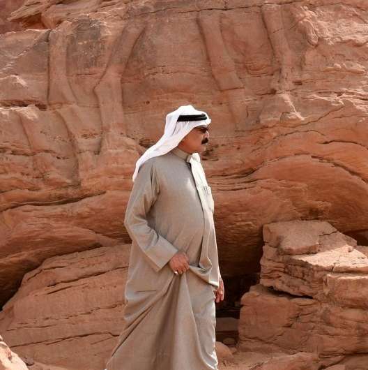 A Saudi man walks at the site of an archaeological discovery in the northwestern province of Al-Jouf with a carved sculpture of 