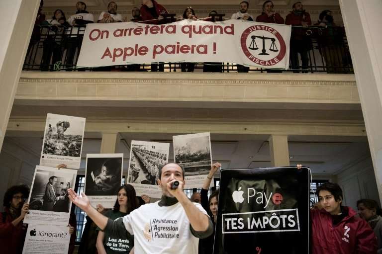 ATTAC has staged protests at Apple outlets in Paris and Aix-en-Provence. Banners held by activists read 'We will stop when Apple