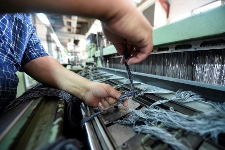 A worker prepares high-quality long-fibre cotton threads at the Marie Louis clothing and textile factory