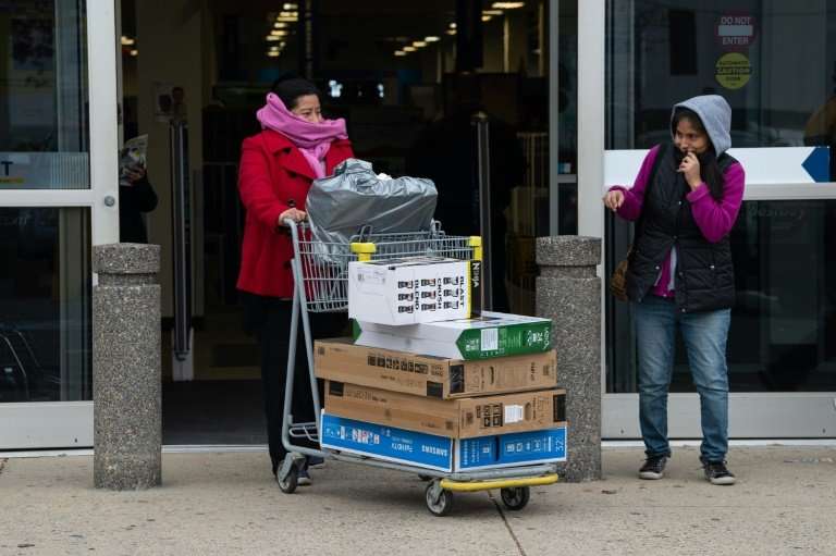 Black Friday shoppers walk out of an electronics store with their purchases in Wheaton, Maryland, on November 23, 2018