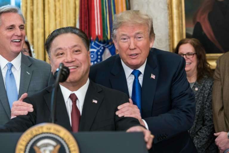 Broadcom CEO Hock Tan is seen at a November 6 White House meeting with President Donald Trump, at which Tan announced plans to m