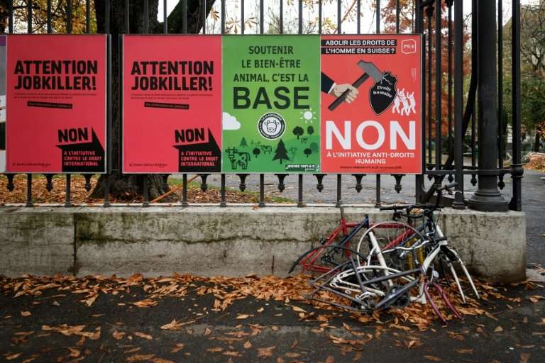 Campaign posters in Geneva draw attention to the three issues on which Swiss are called to vote—including safeguarding cow horns