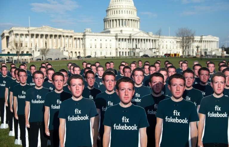 Cardboard cutouts of Facebook CEO Mark Zuckerberg stand outside the US Capitol, placed by advocacy group Avaaz to call attention