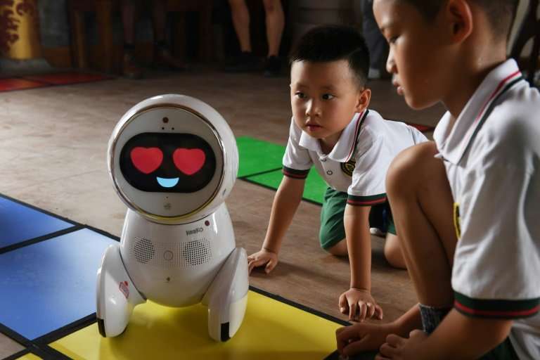 Children watch a Keeko robot at the Yiswind Institute of Multicultural Education in Beijing, where the intelligent machines are 