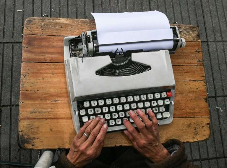 Colombia's street clerks work in the open air on with their typewriters perched on a tiny table in front of them