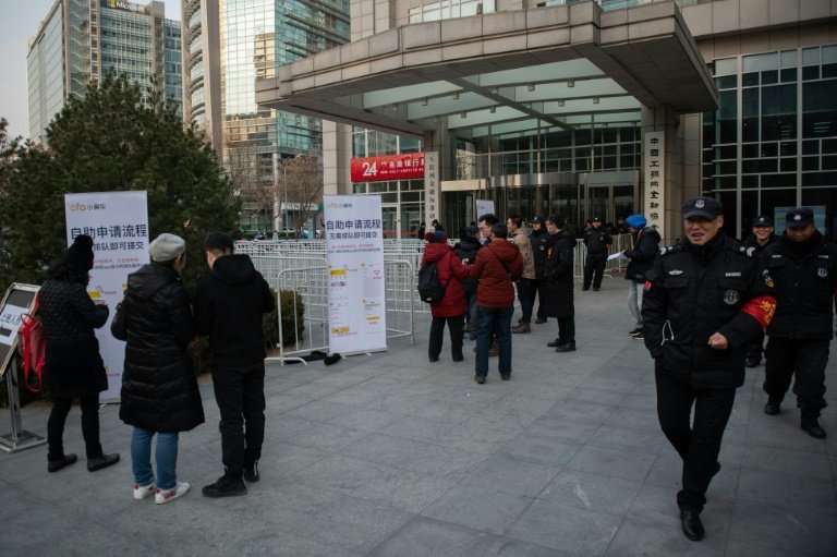 Customers (L and C) come to claim their deposit money, outside Ofo headquarters in Beijing